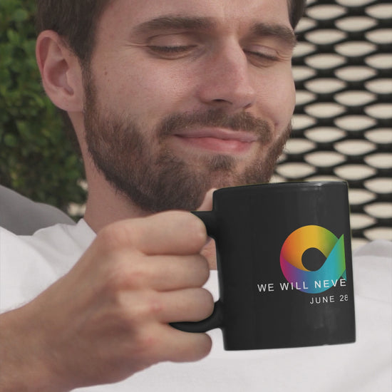 Man Drinking from a  black ceramic Stonewall mug  with an rainbow infinity sign wtih the wording We Will Never Be Silent, June 29, 1969